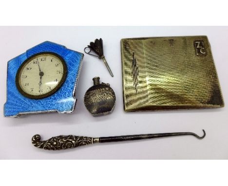 A silver scent bottle, a silver funnel, a silver handled button hook, a guilloche enamel desk clock and an EPNS cigarette cas