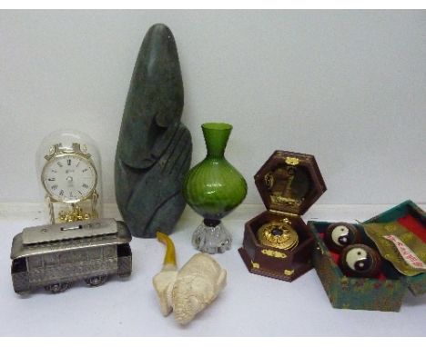 A novelty table lighter in the form of a San Francisco cable car, a Hermle clock, a soapstone carving, a pocket watch and a p