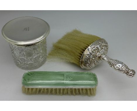 A silver topped glass jar, a silver and enamel brush and a silver brush