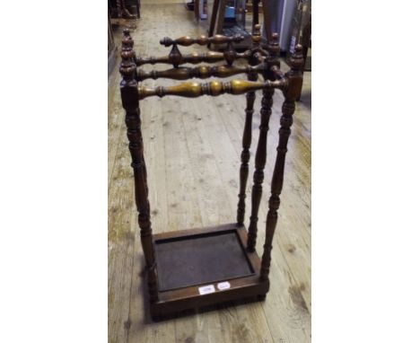 A turned walnut stick stand, 31 cm wide