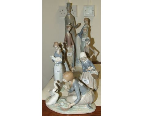 A Lladro group, of a lady and gentleman, 49 cm high, and seven others similar (8)