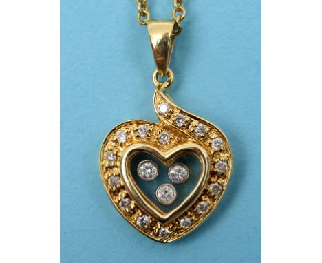 An 18ct yellow gold heart shaped pendant, set three floating diamonds within a surround of diamonds, on an 18ct gold chain  S