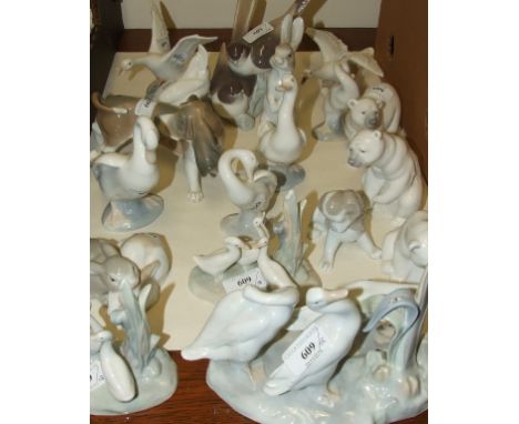 A Lladro dog, 12.5 cm high, three Lladro polar bear cubs, and other Lladro and Nao animals and birds (18)