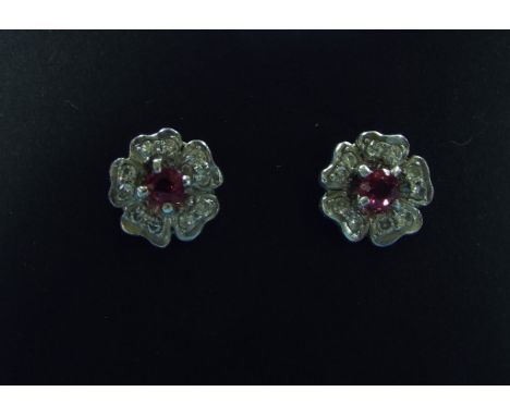 A pair of ruby and diamond flowerhead stud earrings, boxed