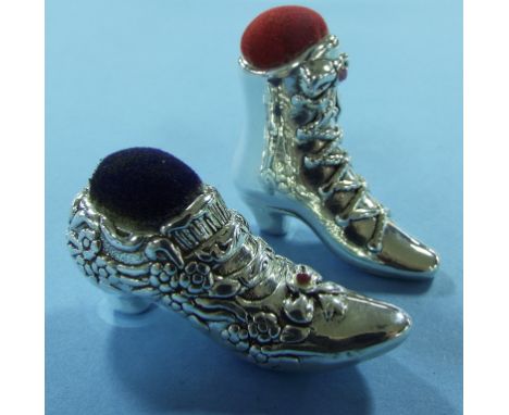 A novelty silver pin cushion, in the form of a boot, and a similar shoe (2)