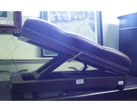 An adjustable gout stool, with a leather upholstered top