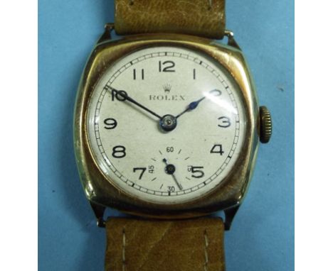A gentleman's 9ct gold Rolex wristwatch, the champagne dial with Arabic numerals and subsidiary seconds dial, in a cushion ca