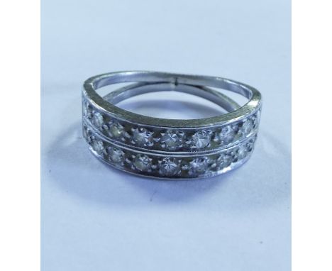 EXTRA LOT: A diamond half hoop ring, set two rows of brilliant cut stones in a white coloured metal mount