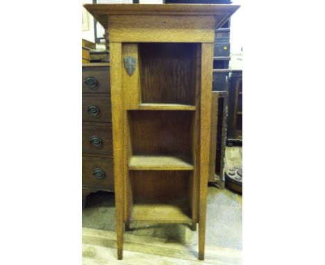 An Arts & Crafts oak open bookcase, applied a metal shield, the back stamped RD504213, 117 cm high Condition report Report by