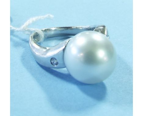 A platinum, pearl and diamond ring