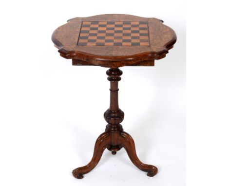 A Victorian walnut games table, the shaped square top having a section inlaid for chess, hinged and with a strut, on a tripod