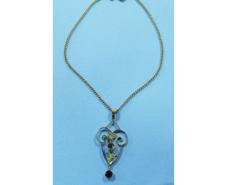 An Edwardian 9ct gold, ruby and seed pearl pendant