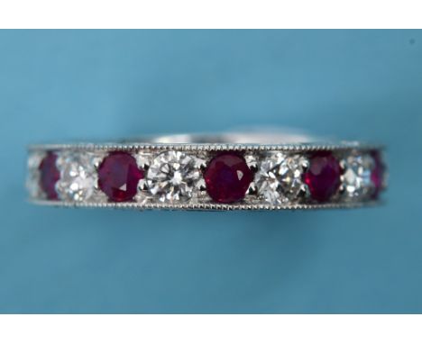 A diamond and ruby eternity ring, in a white coloured metal setting  See illustration