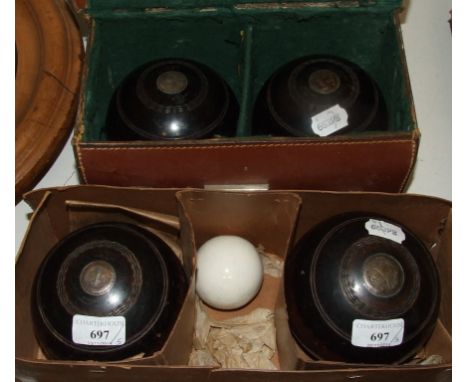 A set of four lignum vitae bowling woods, with silver coloured metal mounts, initialled, Thomas Taylor Glasgow, and a ceramic