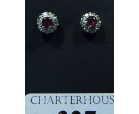 A pair of ruby and diamond stud earrings