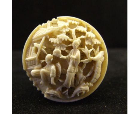 A Cantonese carved ivory box and cover, with mother of pearl counters, 3.5 cm diameter