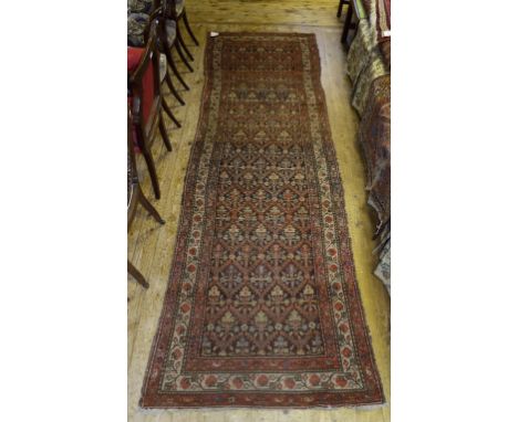 A Persian runner, with geometric lattice motifs, 325 x 106 cm