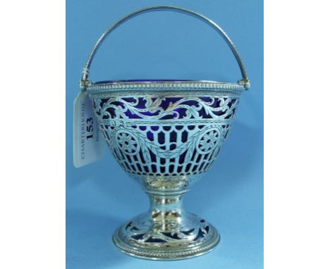 A George III silver swing handle sugar basket, with pierced and engraved decoration, initialled, William Plummer, London 1777