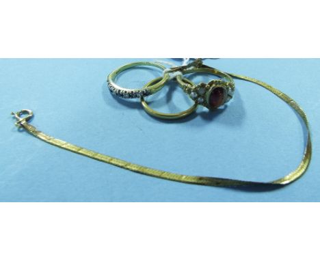 A 9ct gold, cabochon garnet and seed pearl ring, a 22ct gold wedding band, approx. 2.0 g , another ring and a bracelet (4) Co