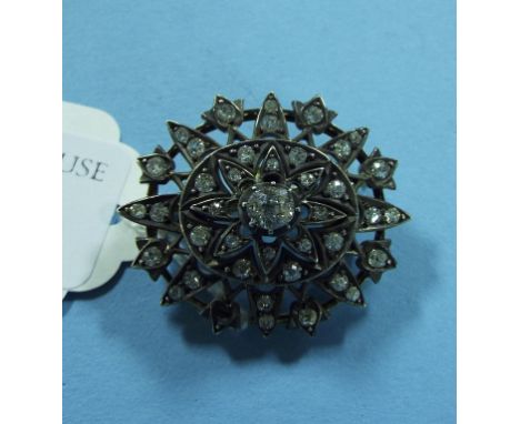 A diamond brooch, with central cushion cut stone (one stone loose)