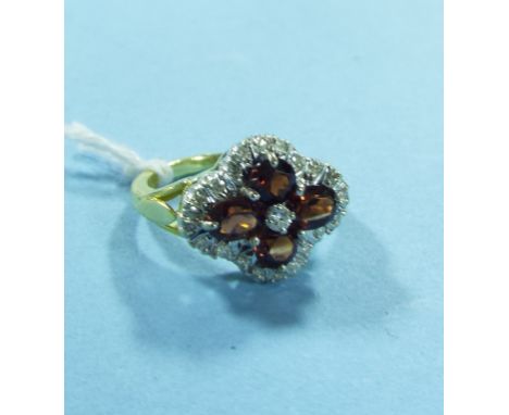 An 18ct gold, garnet and diamond flowerhead cluster ring