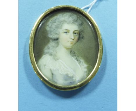 An oval bust portrait miniature, of a lady, 3.5 x 3 cm, in a yellow coloured metal frame