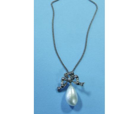 A diamond and pearl pendant, the ribbon tie set diamonds above a pearl drop, on a white coloured metal chain
