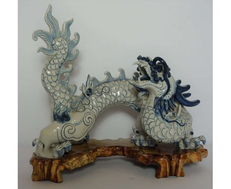 A large Chinese ceramic decorative 'Imperial' five clawed dragon, late 20th century. standing with head raised, decorated wit