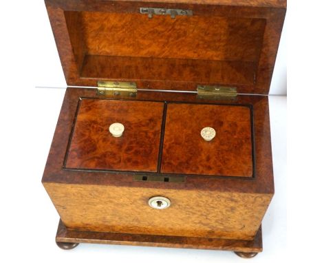 A late Regency birds eye maple veneered tea caddy, fitted with two compartments, of sarcophagus form, 16cm high, 20cm wide; t
