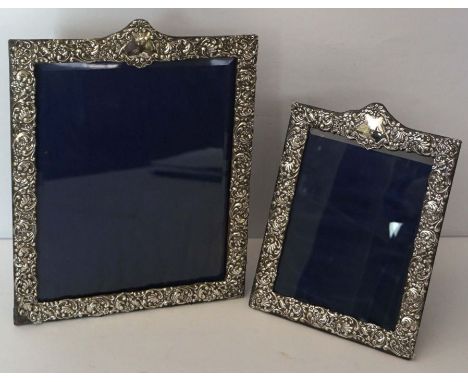 A graduated pair of silver mounted portrait frames, hallmarked Birmingham 1901/1903, maker Henry Matthews, each with an embos