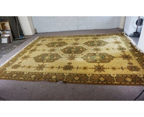 A large Caucasian style carpet, decorated with medallions, with light yellow motifs on cream ground, 370cm x 270cmCondition r