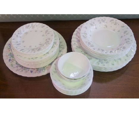 A Wedgwood bone china ‘April Flowers’ pattern part dinner service, comprising nine dining plates, ten dessert plates, six tea