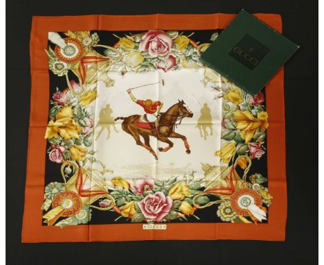 A Gucci silk scarf,terracotta, black and cream ground, with polo horse print, in original box