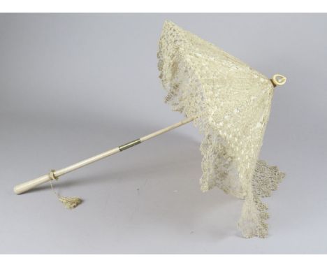 A Victorian lace parasol, with white painted wooden handle, handmade lace over a silk enclosed interior, with ivory loop fini