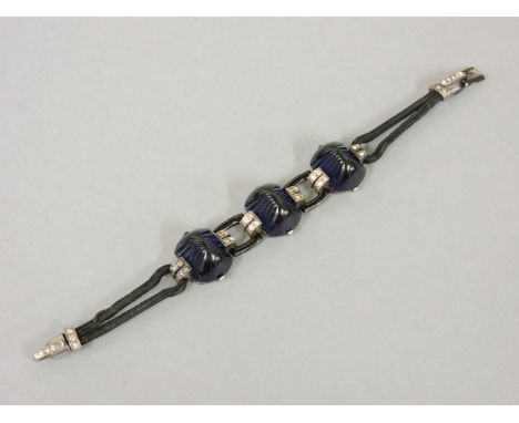 A French silver, paste and enamel Art Deco bracelet, c.1935,a centrepiece of moulded blue paste cabochons between pairs of ar