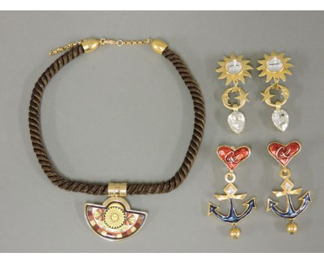 A gold-plated Michaela Frey enamel necklace,with a lunette-shaped pendant to a brown silk cord with adjustable back chain, ma