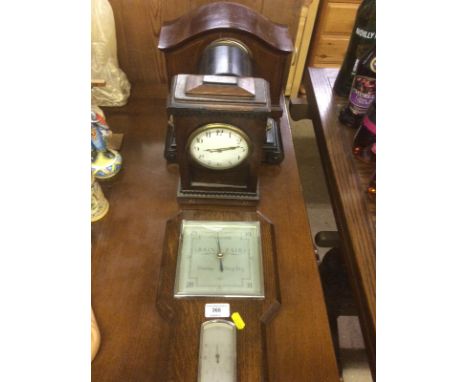 Three various mantel clocks and an oak cased barometer