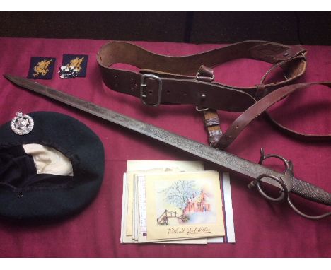 A Wilkinson fighting knife in leather scabbard; a Toledo sword; a leather belt etc. 