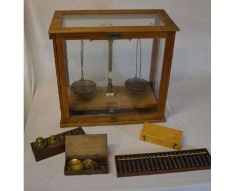 Cased balance scales, miniature scales, an abacus and various weights