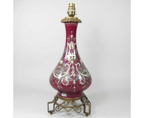 A 19th century continental red pottery converted oil lamp base, decorated with masks, 48cm high