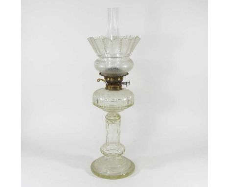 A 19th century German patent clear glass oil lamp, with a faceted body and clear etched glass shade, 54cm highVery dirty. Wea