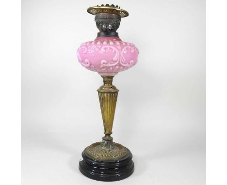 A Victorian brass oil lamp base, with a pink glass font, 48cm high