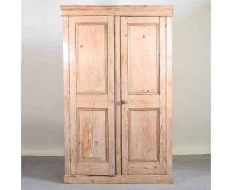 An antique pine cupboard, early 20th century, enclosed by a pair of panelled doors126w X 63d X 201h cmOverall complete and us