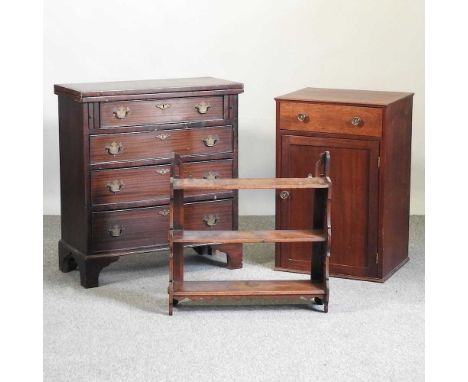 A George III style mahogany chest of drawers, with a fold over top, 69 x 30 x 73cm, together with a bedside cabinet and a thr