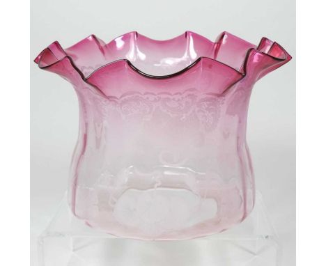 A red glass oil lamp shade, of frilled shape, with etched decoration,
