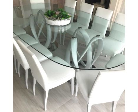 A Porada Infinity dining table, with an oval glass top, on a composition support and mirrored base, 260 x 141cm, together wit