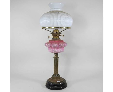 A 19th century brass oil lamp, with pink glass font and white opaque glass shade, 66cm highOverall solid and usable. The blac