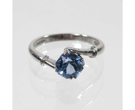 An 18 carat aquamarine and diamond ring, the central rose cut stone, crossover set, with a single diamond to each side, 3.4g,