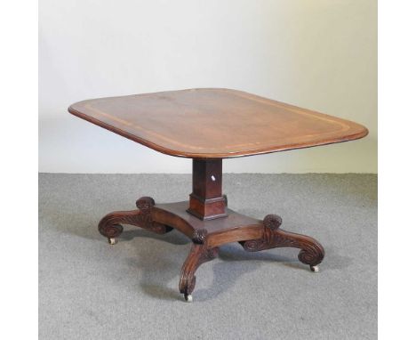 A Regency mahogany and crossbanded breakfast table, of hinged rectangular shape, on a square column and carved quadruped base