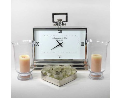 A large modern mantel clock, signed McClaughlin &amp; Scott, 46cm wide, together with a pair of Neptune glass storm lanterns 